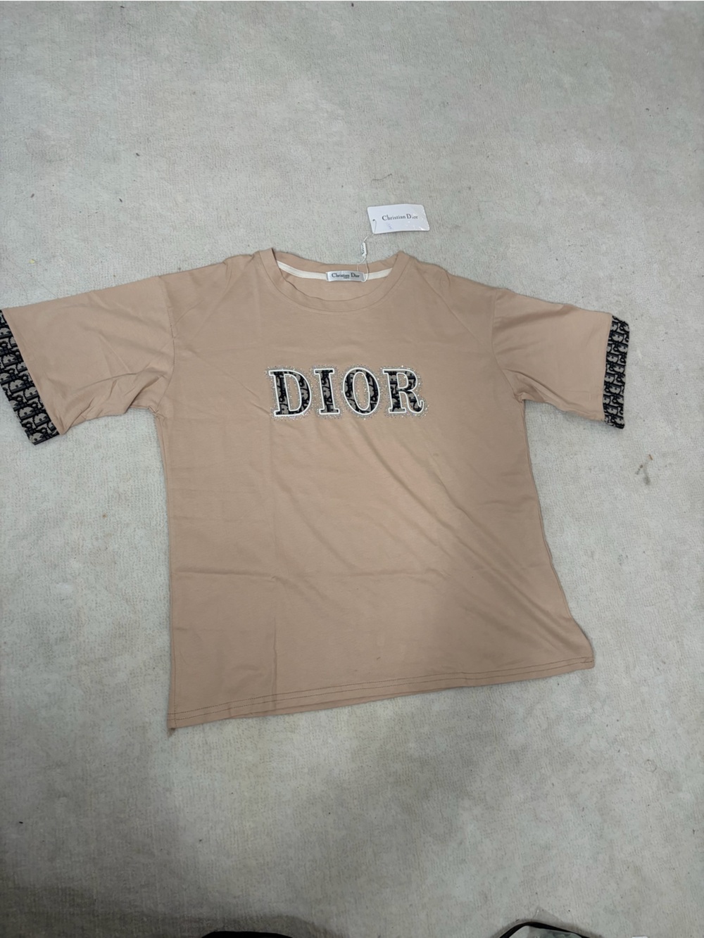 A beige T-Shirt with a flat materials Unbranded design/22x26 in/for M-L size
